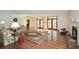 Spacious living room with hardwood floors, fireplace, and multiple french doors leading to the outside at 115 Russell Rd, Roswell, GA 30075