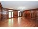 Large living room with hardwood floors, ample natural light, and custom wood paneling at 115 Russell Rd, Roswell, GA 30075