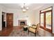 Cozy living room features a marble fireplace, hardwood floors, and French doors leading to an outdoor balcony at 115 Russell Rd, Roswell, GA 30075