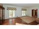 Comfortable living room with hardwood floors, large windows, and a wooden display cabinet at 115 Russell Rd, Roswell, GA 30075