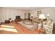 Hardwood floors in a spacious living room with a fireplace and plenty of room for seating at 115 Russell Rd, Roswell, GA 30075