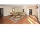 Large living room with hardwood flooring, decorative rug, and comfortable seating arrangements at 115 Russell Rd, Roswell, GA 30075