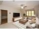 Spacious living room featuring recessed lighting, a ceiling fan, and a large TV at 115 Russell Rd, Roswell, GA 30075