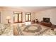 Bright living room features hardwood floors, a fireplace, and French doors leading to a balcony at 115 Russell Rd, Roswell, GA 30075
