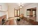 Living room featuring a fireplace with marble surround, hardwood floors, and access to the outdoors at 115 Russell Rd, Roswell, GA 30075