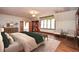 Spacious main bedroom featuring hardwood floors, built-in bookcases, and two large sitting chairs at 115 Russell Rd, Roswell, GA 30075