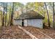 Outdoor shot of gray outbuilding in backyard with open door at 115 Russell Rd, Roswell, GA 30075