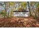 Exterior shot of gray backyard outbuilding with fence at 115 Russell Rd, Roswell, GA 30075