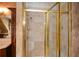 Shower featuring tiled walls and glass door with a shower head in a well-maintained bathroom at 115 Russell Rd, Roswell, GA 30075