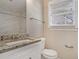 Bathroom with granite countertop, white vanity, and tiled shower at 1761 Derrill Dr, Decatur, GA 30032
