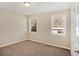 Bright bedroom with neutral walls, carpet, and two large windows at 1761 Derrill Dr, Decatur, GA 30032
