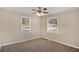 Spacious bedroom with ceiling fan, neutral walls, and two windows at 1761 Derrill Dr, Decatur, GA 30032