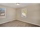 Well-lit bedroom featuring neutral walls, carpet, and a window offering natural light at 1761 Derrill Dr, Decatur, GA 30032