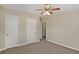 Bedroom with ceiling fan, neutral walls, and double closets at 1761 Derrill Dr, Decatur, GA 30032