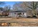 Newly painted brick ranch house with mature trees and a big yard at 1761 Derrill Dr, Decatur, GA 30032