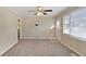 Bright living room featuring neutral walls, new carpet, and ceiling fan at 1761 Derrill Dr, Decatur, GA 30032