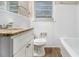 Clean bathroom with granite countertop and white tile at 2372 Tyler Way, Decatur, GA 30032