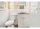 Clean bathroom with white tile, granite vanity and updated fixtures at 2372 Tyler Way, Decatur, GA 30032