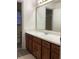 Bathroom featuring a large mirror, neutral paint, and wood cabinets at 35 Fairfield Dr, Ellenwood, GA 30294