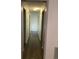 Long hallway featuring neutral paint, white trim, and vinyl plank flooring at 35 Fairfield Dr, Ellenwood, GA 30294