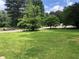 A tranquil street scene featuring well-maintained lawns and mature trees lining the roadway at 35 Fairfield Dr, Ellenwood, GA 30294