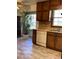Traditional kitchen featuring wood cabinets, laminate countertops, and vinyl plank flooring at 35 Fairfield Dr, Ellenwood, GA 30294