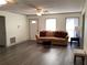 Cozy living room featuring neutral paint, plush couch, and vinyl flooring at 35 Fairfield Dr, Ellenwood, GA 30294