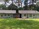 Charming single-story home with a well-manicured front yard and mature trees at 35 Fairfield Dr, Ellenwood, GA 30294