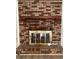 Living room with a brick fireplace and modern flooring, perfect for relaxation at 35 Fairfield Dr, Ellenwood, GA 30294