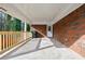 Covered back porch with wood railing and concrete flooring at 5310 Timbo Ln, Mableton, GA 30126