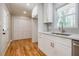 White kitchen cabinets, quartz countertops, and hardwood floors at 5310 Timbo Ln, Mableton, GA 30126