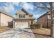 Two-story house with a beige exterior, two car garage, and manicured lawn at 6543 Woodwell Dr, Union City, GA 30291