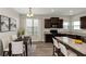 Eat in kitchen with granite countertops and dark brown cabinets at 6543 Woodwell Dr, Union City, GA 30291