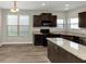 Eat in kitchen with granite countertops and dark brown cabinets at 6543 Woodwell Dr, Union City, GA 30291