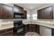 Kitchen with granite countertops and dark brown cabinets at 6543 Woodwell Dr, Union City, GA 30291