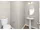 Clean powder room features a pedestal sink, toilet, and elegant mirror at 6543 Woodwell Dr, Union City, GA 30291