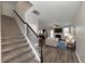View of a carpeted staircase leading to an open living area with hardwood floors at 6543 Woodwell Dr, Union City, GA 30291