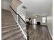 View of a carpeted staircase leading to an open living area with hardwood floors at 6543 Woodwell Dr, Union City, GA 30291