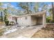 Ranch style home with carport and landscaped yard at 3395 Springlake Dr, Decatur, GA 30032