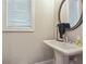 Clean bathroom with pedestal sink, mirror and window at 667 Crosshaven Dr, Marietta, GA 30066