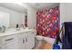 Bathroom with tub shower, white vanity, and floral shower curtain at 667 Crosshaven Dr, Marietta, GA 30066
