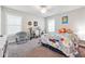 Cozy bedroom with city-themed bedding and a comfy chair at 667 Crosshaven Dr, Marietta, GA 30066