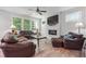 Spacious living room with a fireplace and leather furniture at 667 Crosshaven Dr, Marietta, GA 30066