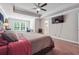 Main bedroom with king bed, ceiling fan, and large TV at 667 Crosshaven Dr, Marietta, GA 30066