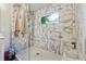 Large walk-in shower with marble tile and built-in seat at 667 Crosshaven Dr, Marietta, GA 30066