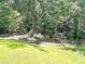 Landscaped backyard with grassy areas and trees at 20 Mountain Ridge Ne Rd, White, GA 30184