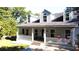 Two story house with wrap around porch, gray siding, and white columns at 20 Mountain Ridge Ne Rd, White, GA 30184