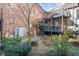 Brick building featuring private balconies with outdoor seating and a landscaped courtyard at 3091 Colonial Way # E4, Chamblee, GA 30341