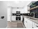 Bright kitchen features white cabinets, stainless steel appliances, and modern backsplash at 3091 Colonial Way # E4, Chamblee, GA 30341