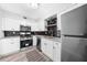 Modern kitchen with stainless steel appliances, white cabinets and trendy dark backsplash at 3091 Colonial Way # E4, Chamblee, GA 30341